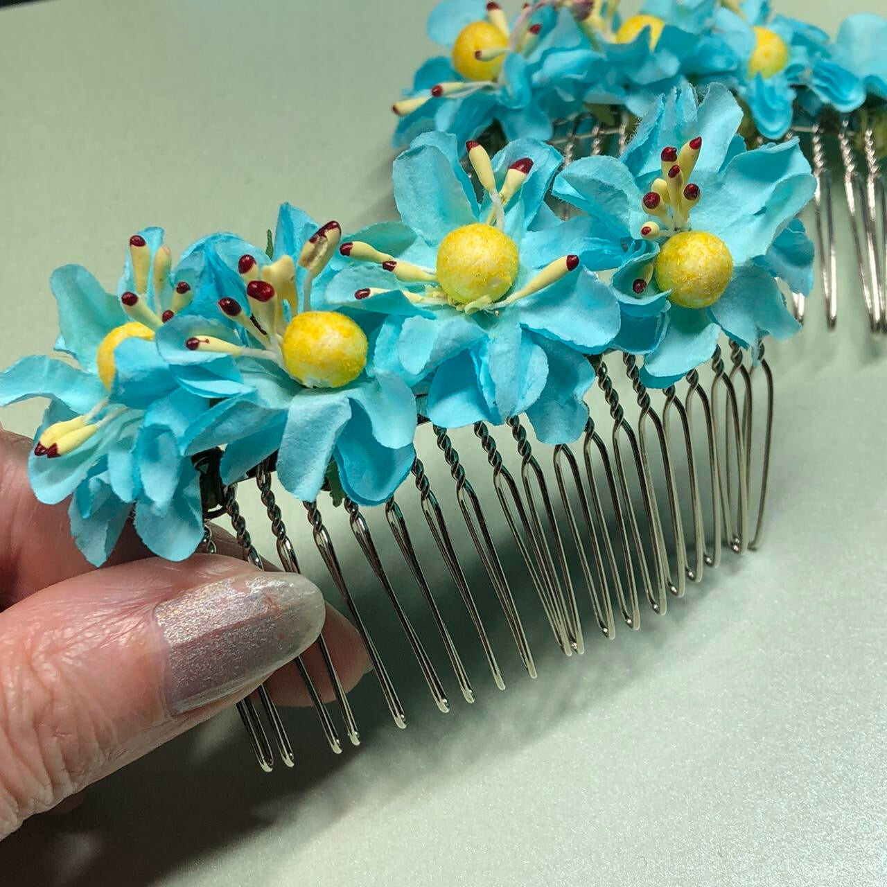 Two turquoise paper flower hair slides