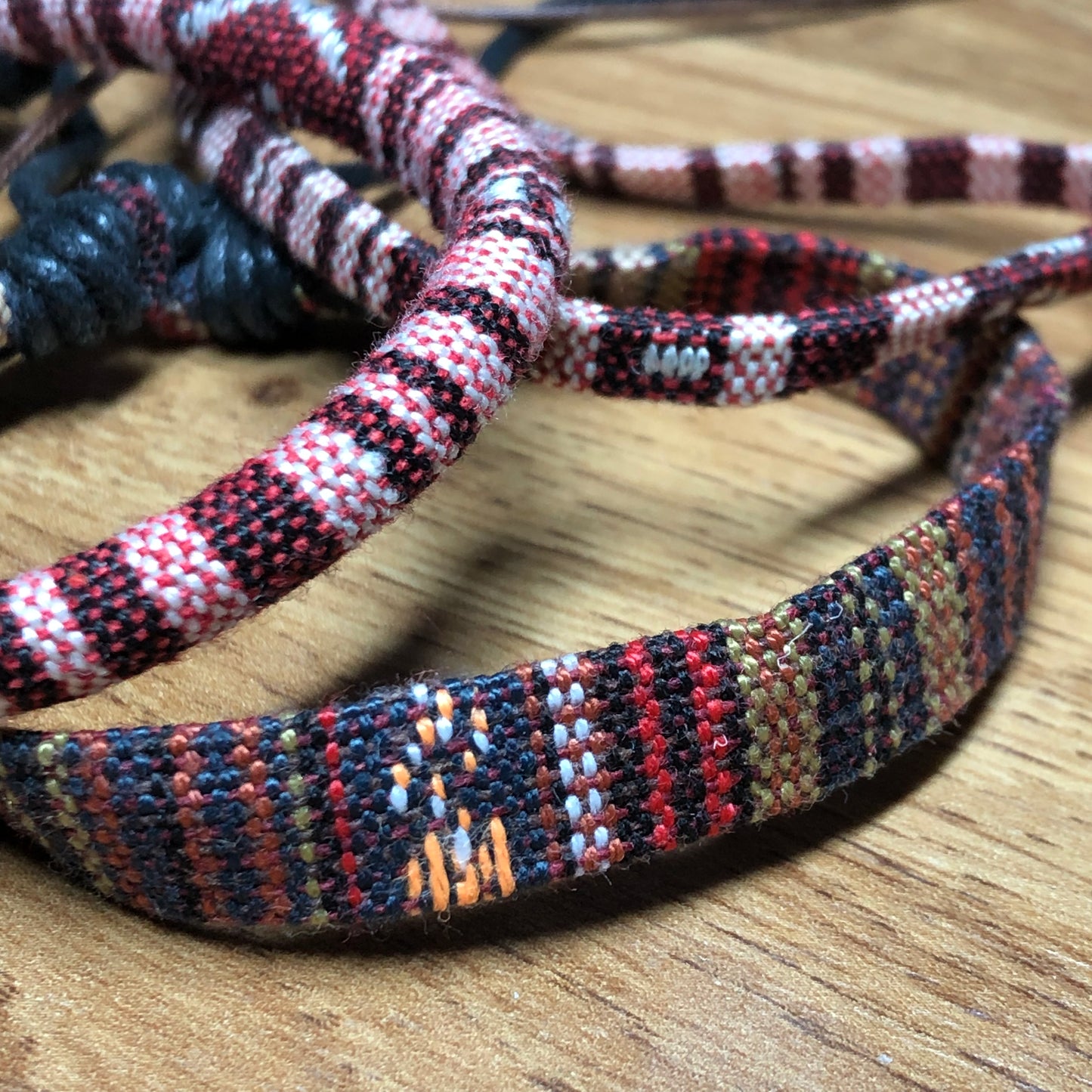 Three brown handmade Bohemian cord braided woven stackable bracelets