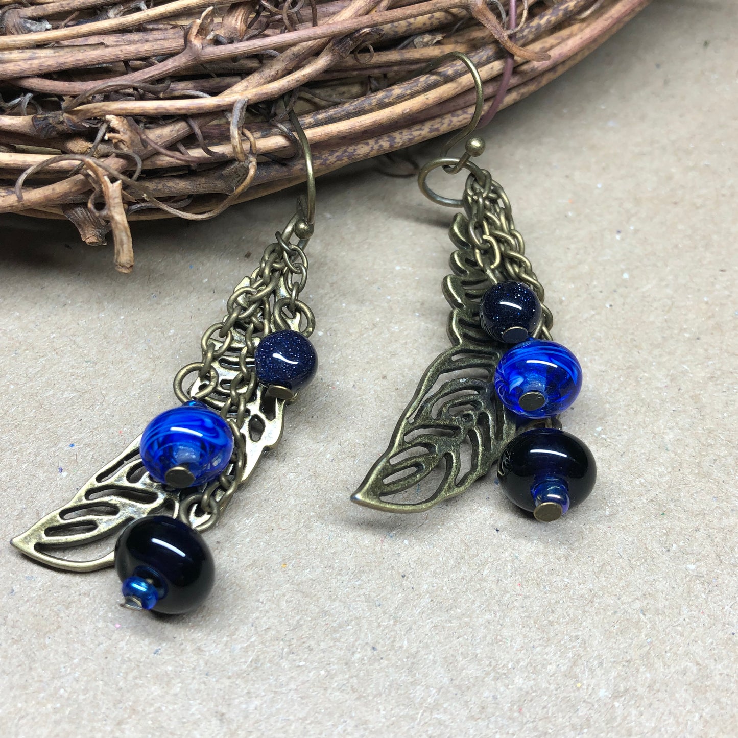 Skadi - Goldstone and artisan glass feather earrings