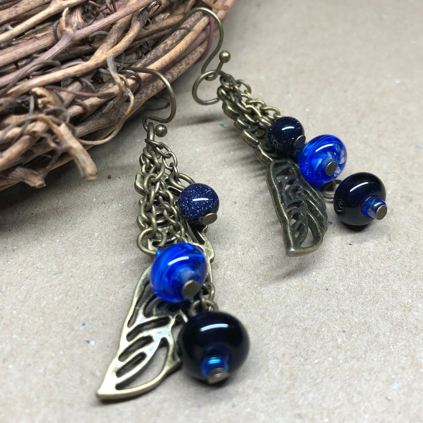 Skadi - Goldstone and artisan glass feather earrings