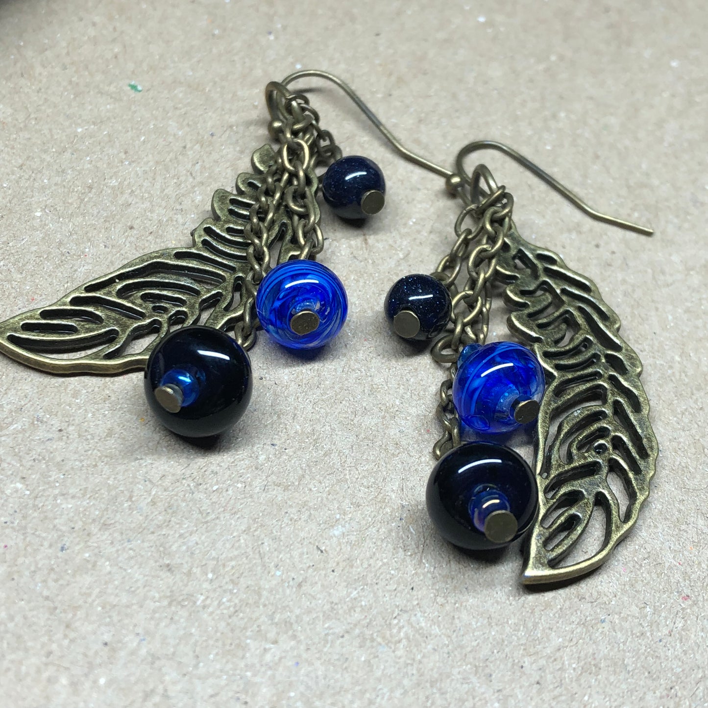 Skadi - Goldstone and artisan glass feather earrings