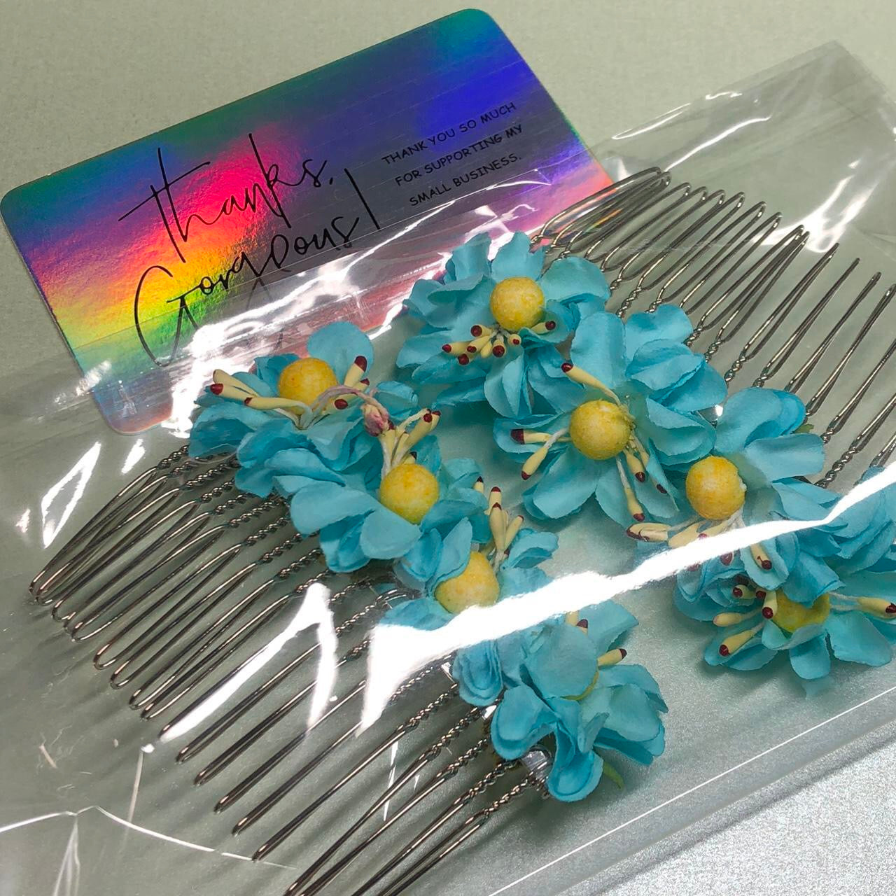 Two turquoise paper flower hair slides