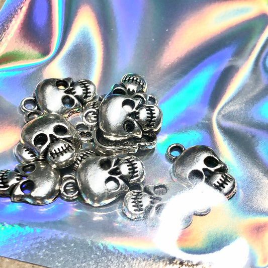 Twelve skull head charms