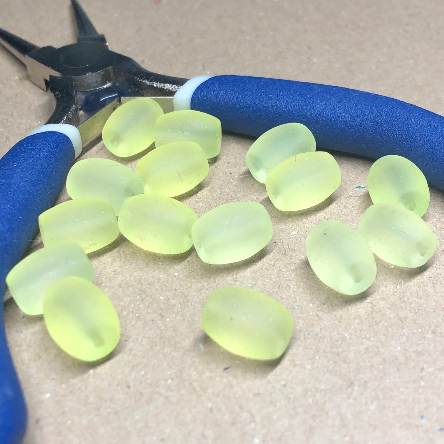 Yellow rubber coated oval glass beads