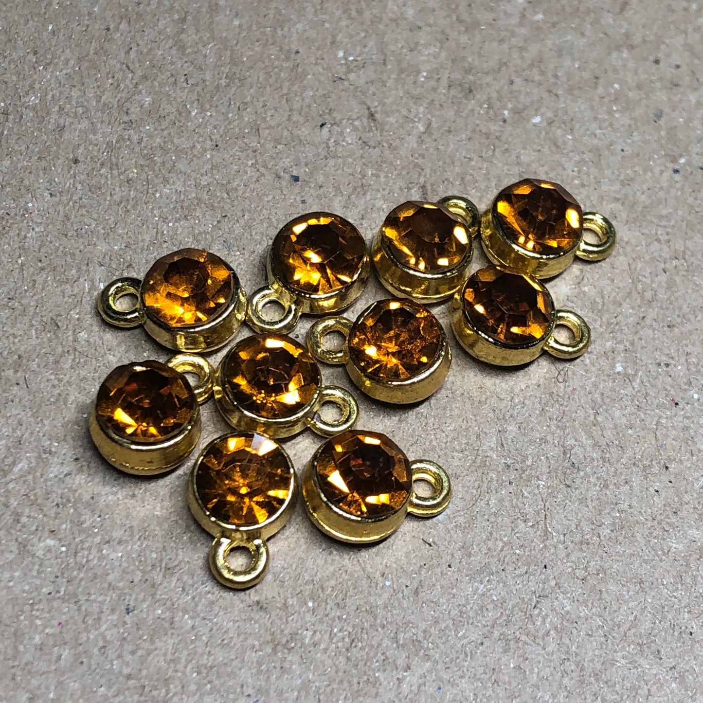 Ten amber rhinestone pendant charms