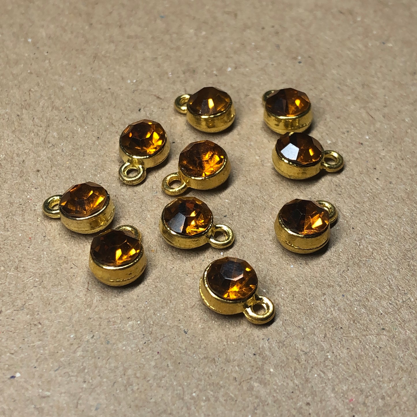 Ten amber rhinestone pendant charms