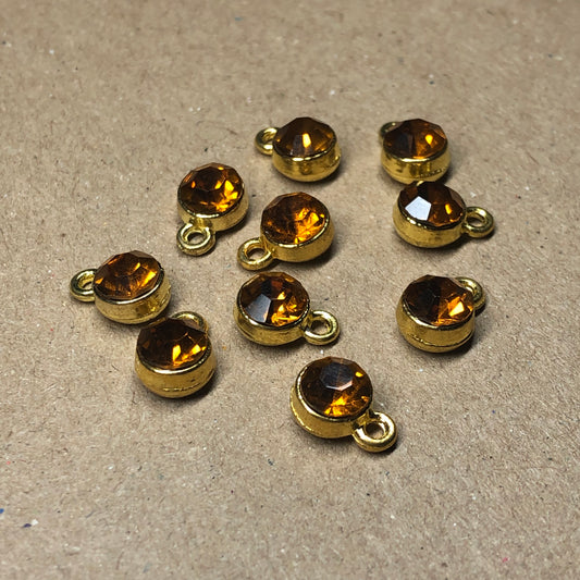 Ten amber rhinestone pendant charms