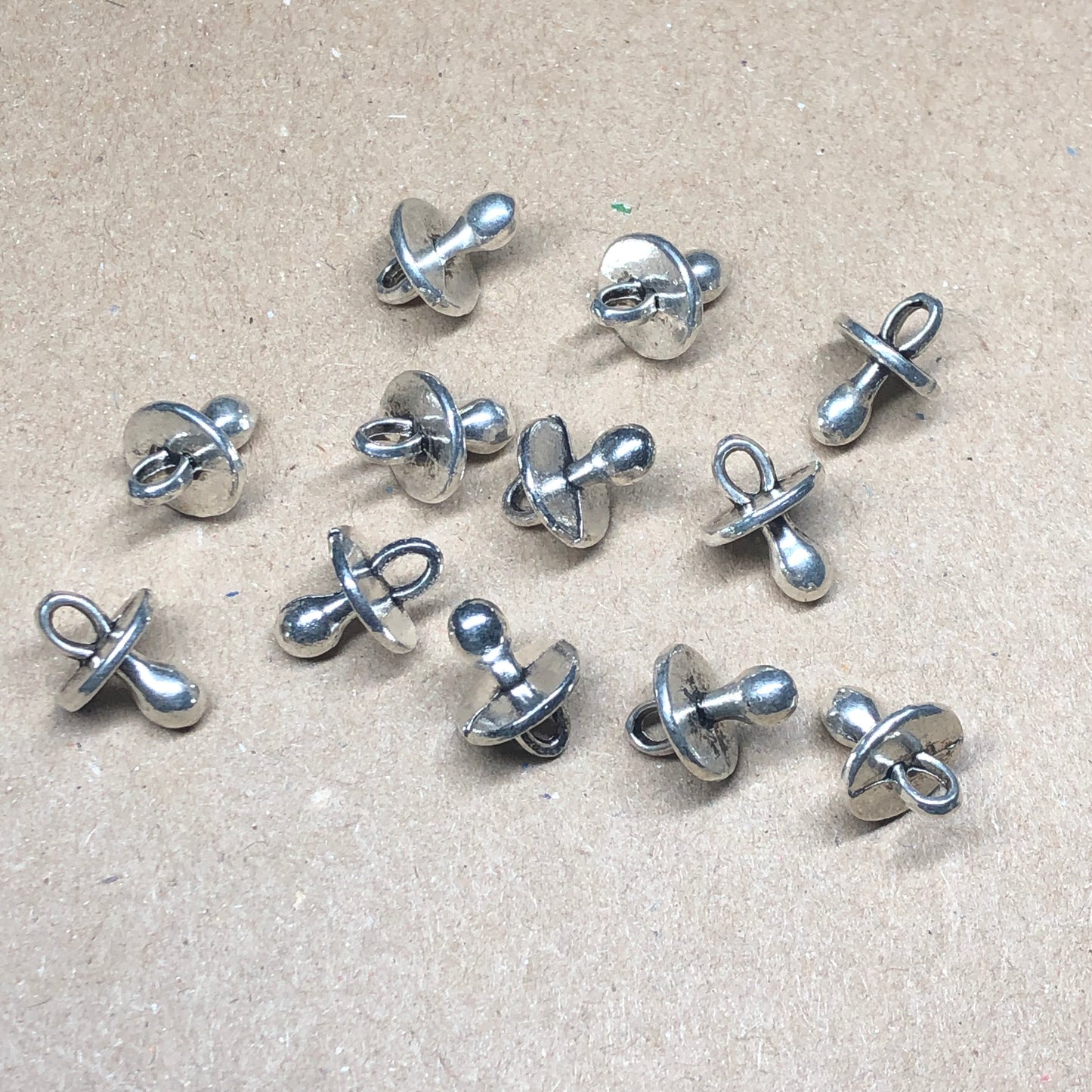 Twelve baby pacifier dummy charms