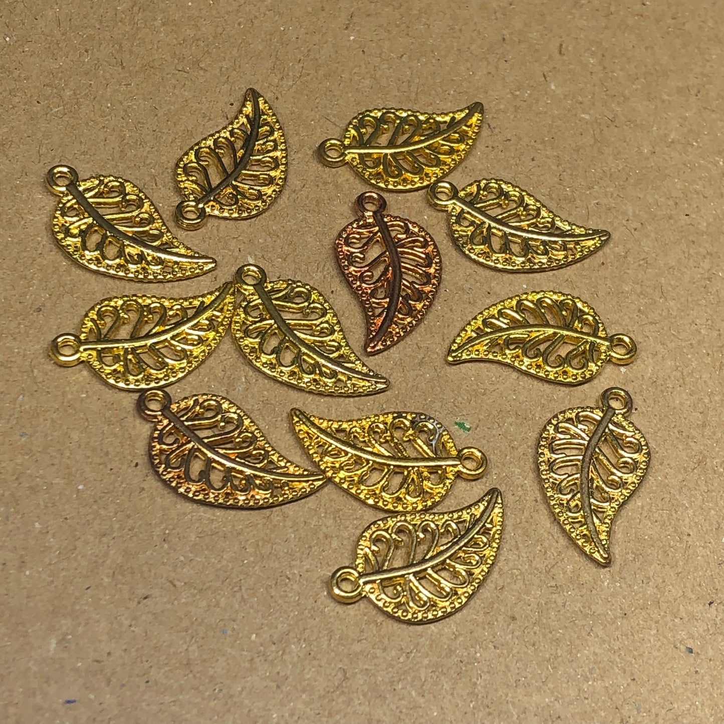 Twelve filigree leaf charms