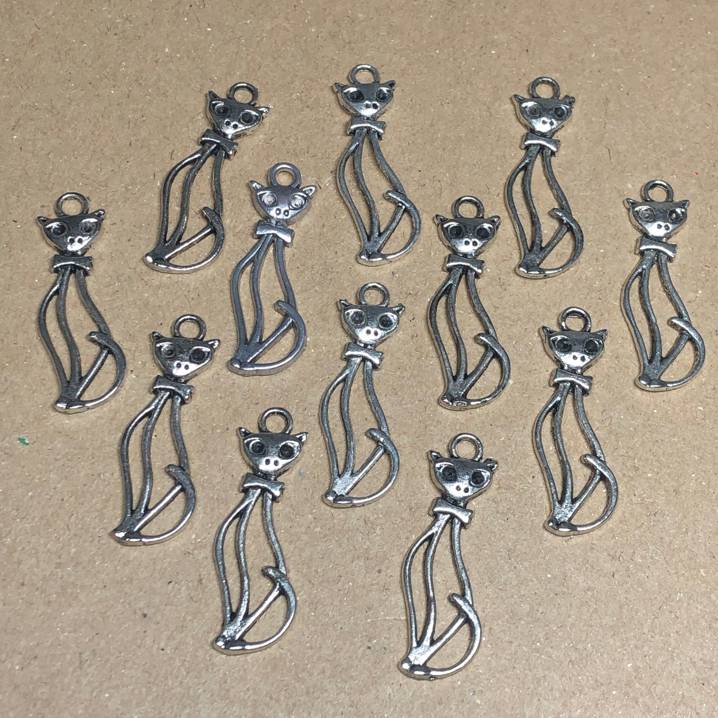 Twelve tall cat outline charms