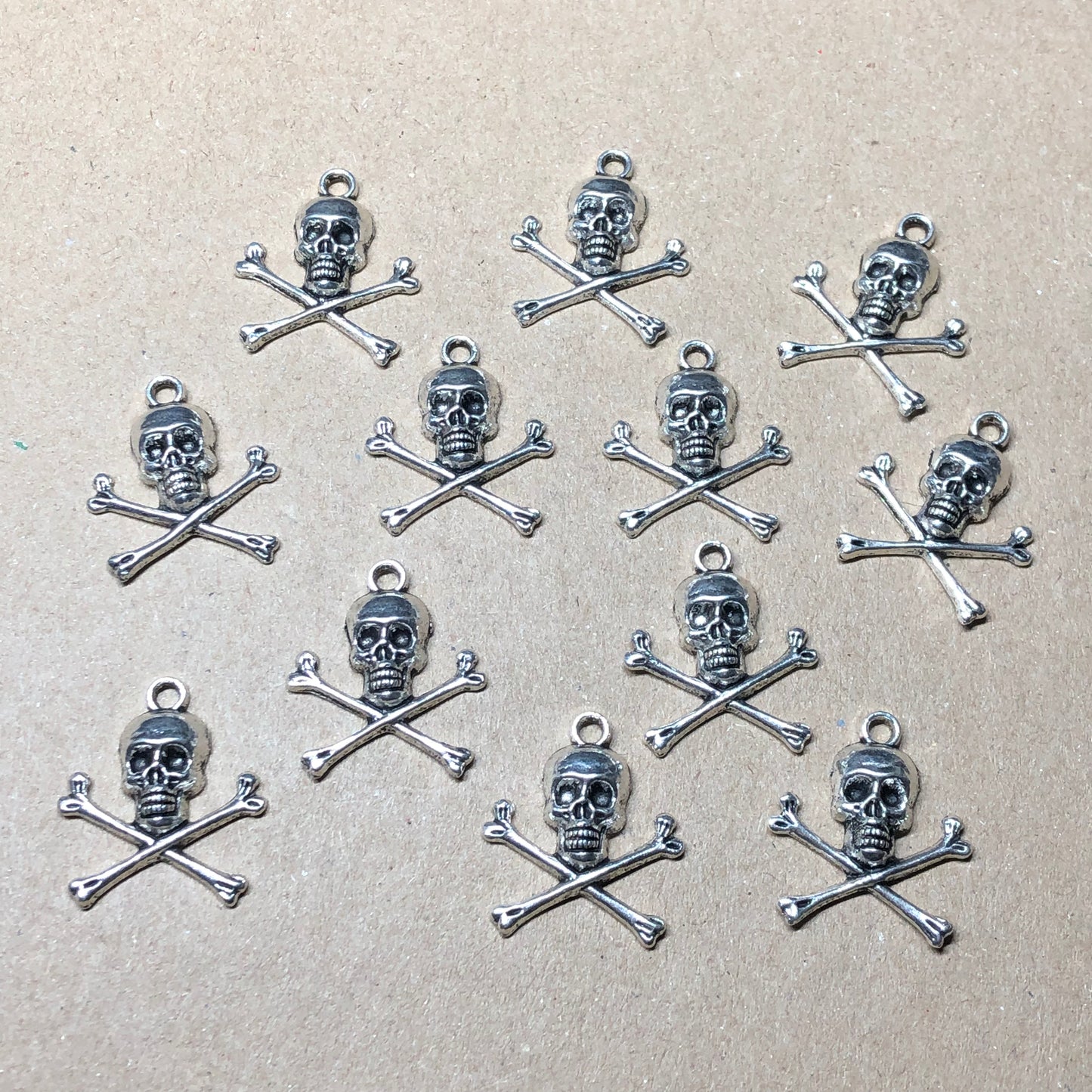 Twelve skull and crossbones charms