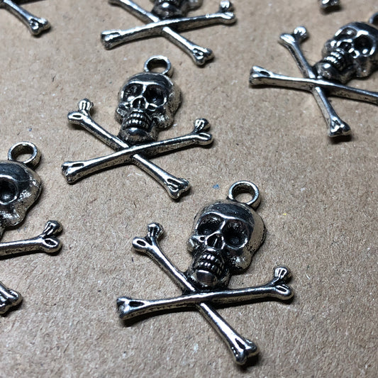 Twelve skull and crossbones charms