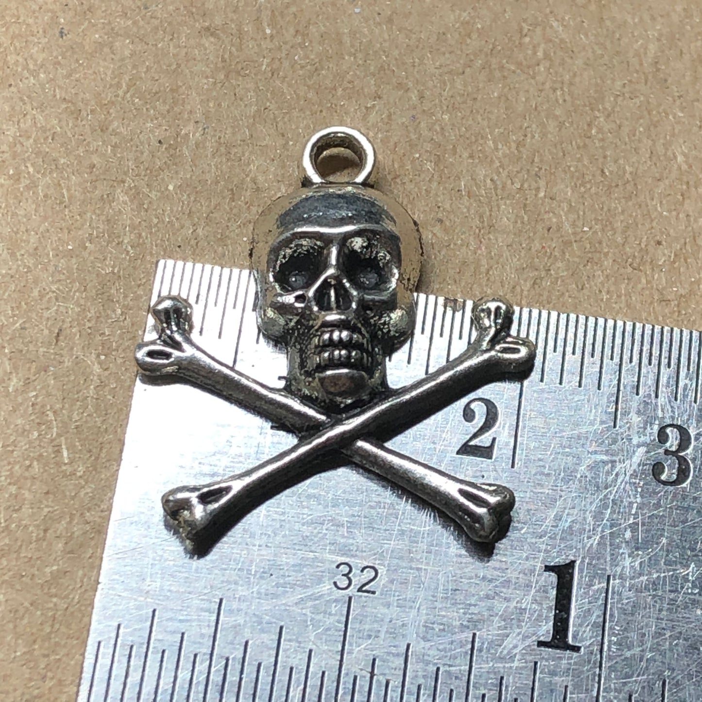 Twelve skull and crossbones charms