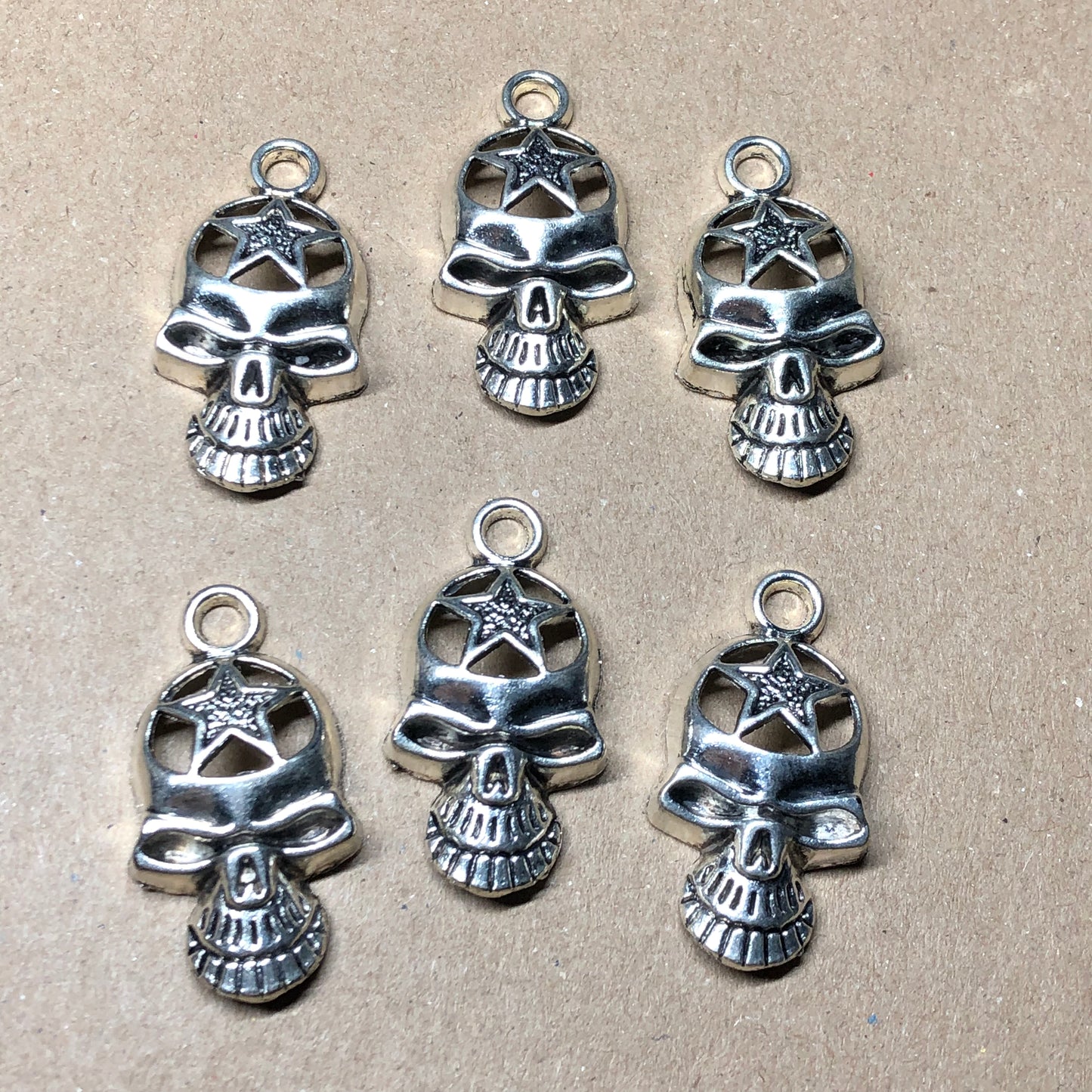 Six large skull charms