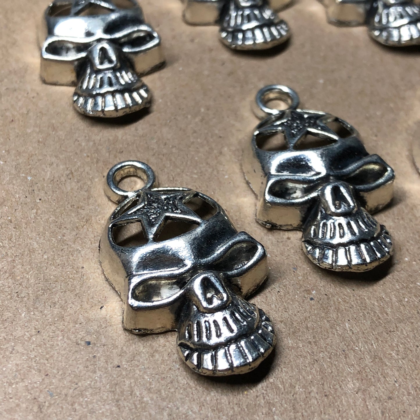 Six large skull charms