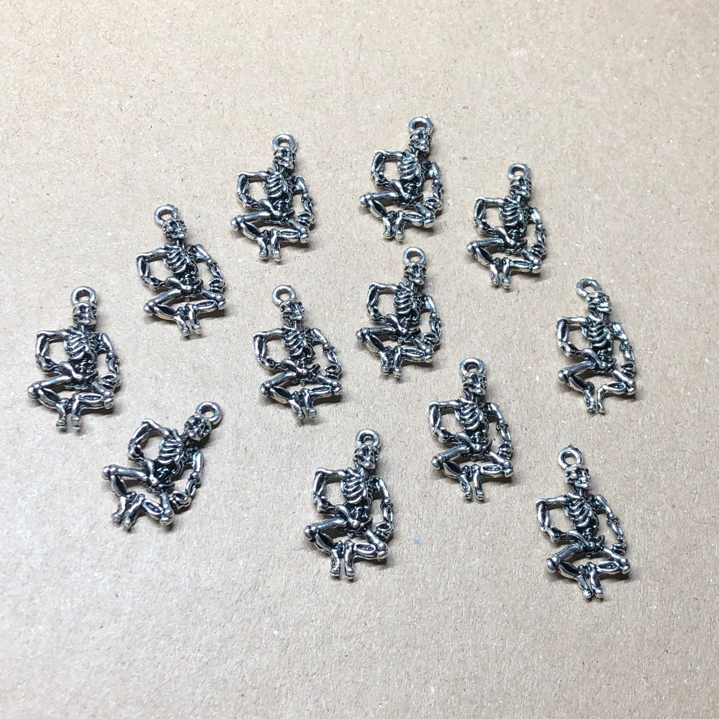 Twelve dancing skeleton charms