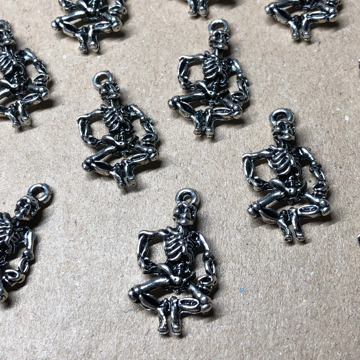 Twelve dancing skeleton charms