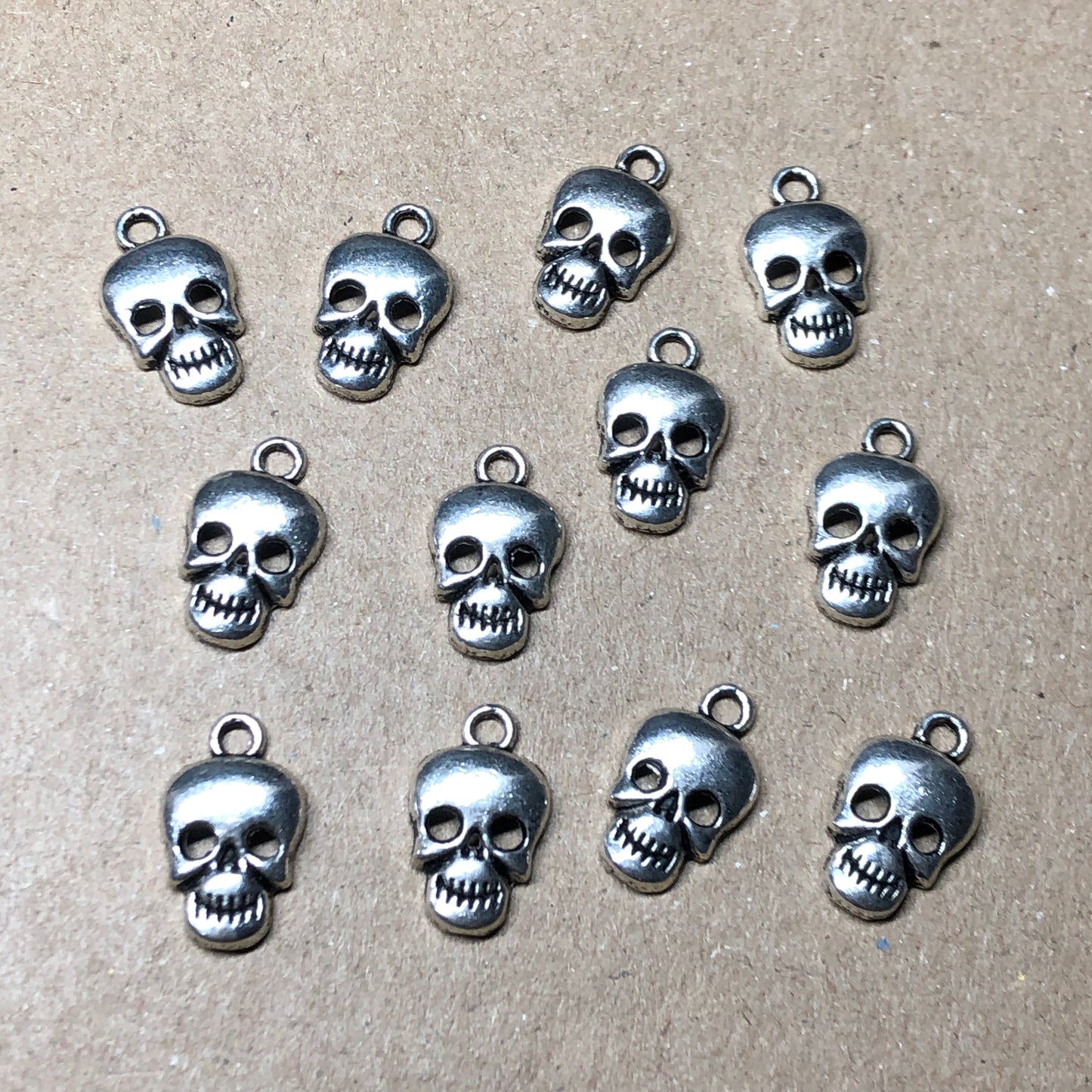 Twelve skull head charms