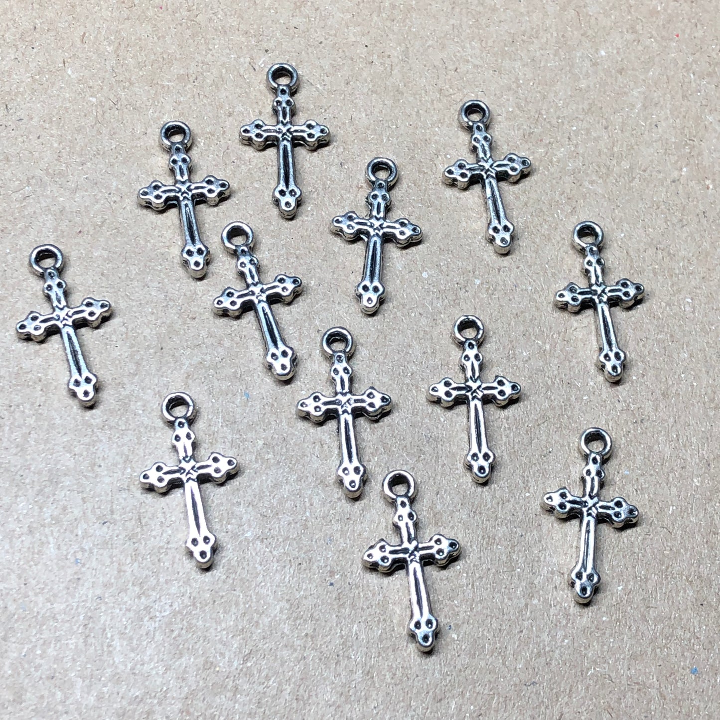 Twelve crucifix cross charms