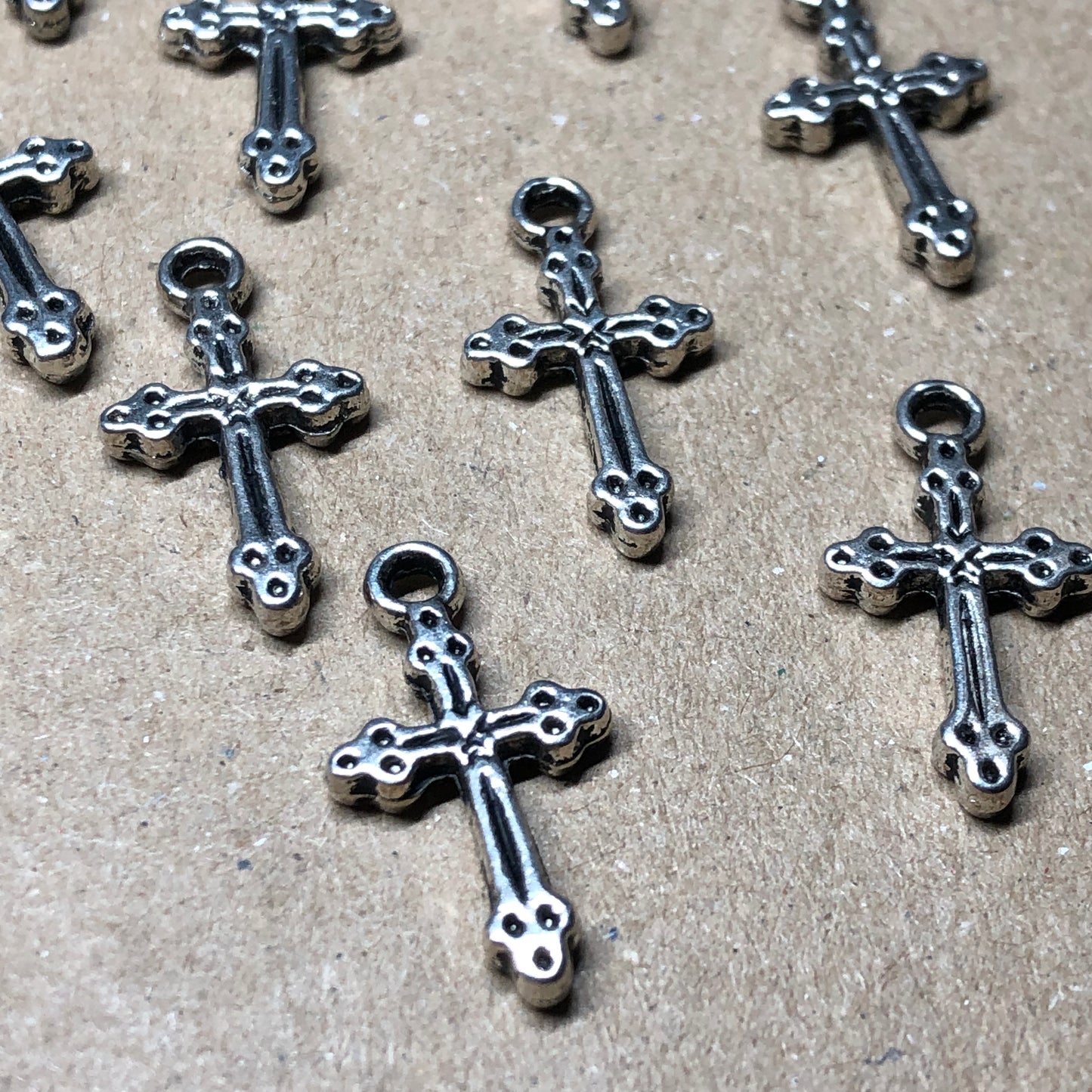 Twelve crucifix cross charms