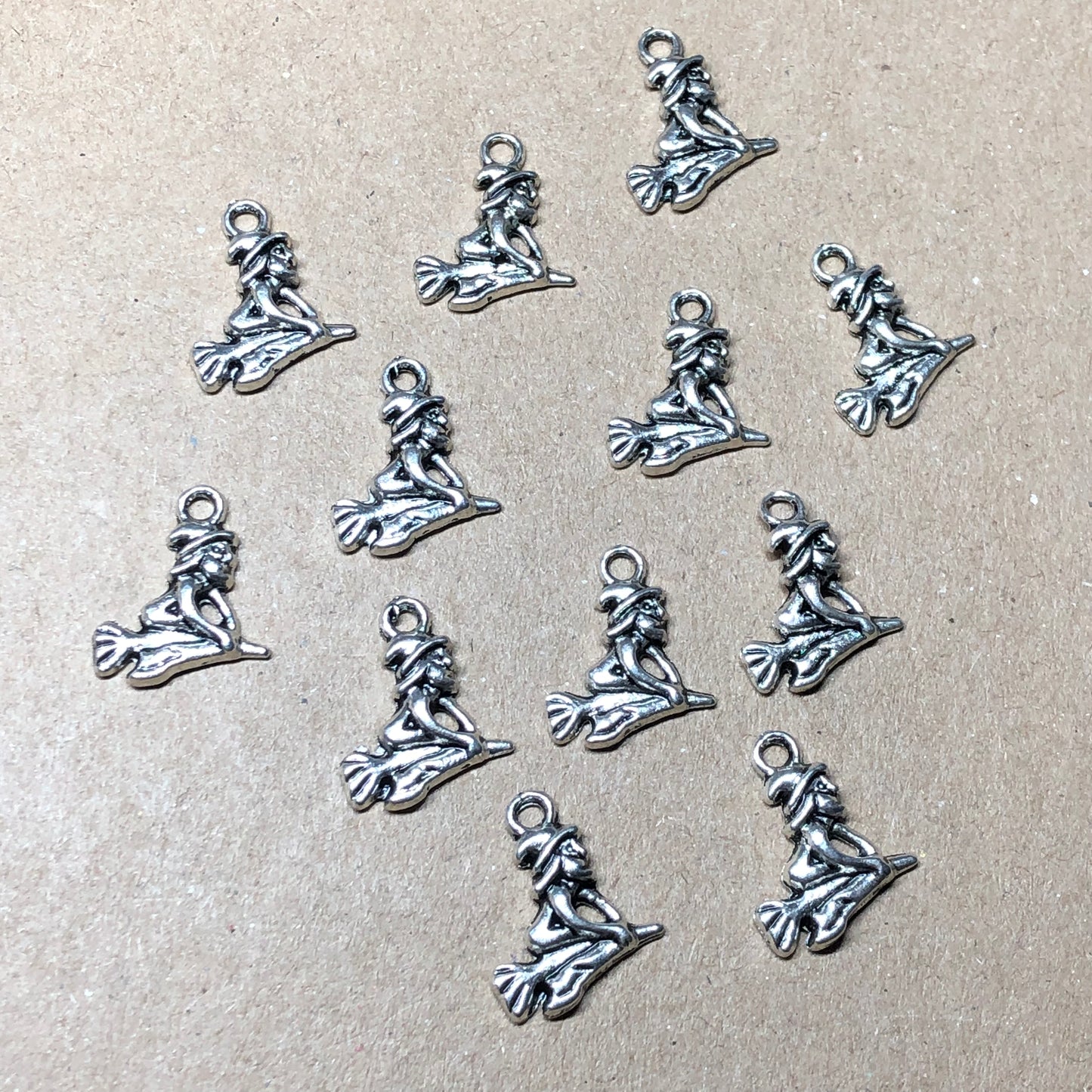 Twelve witch on broomstick charms