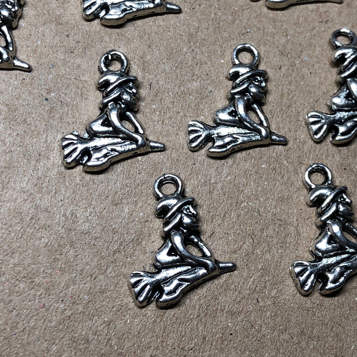 Twelve witch on broomstick charms