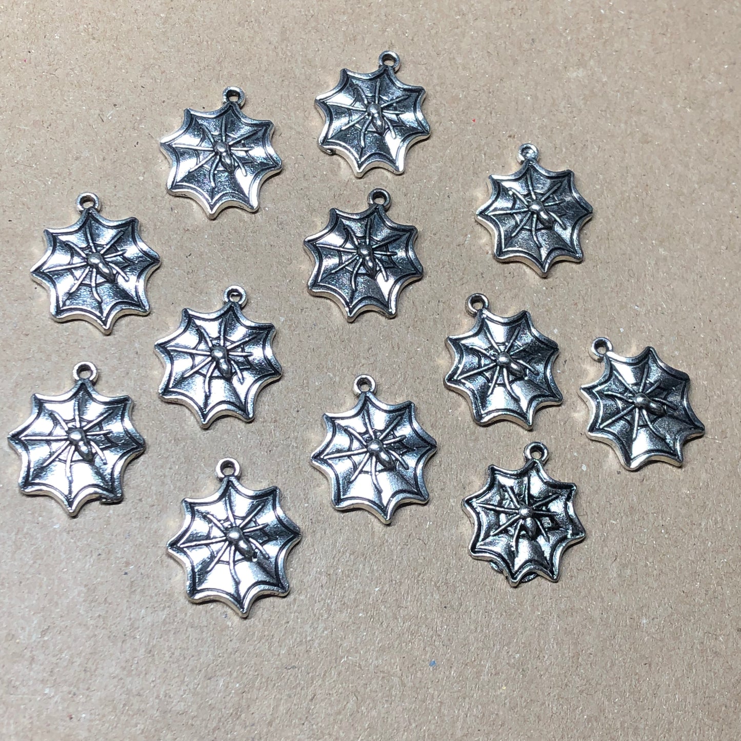 Twelve spiderweb charms