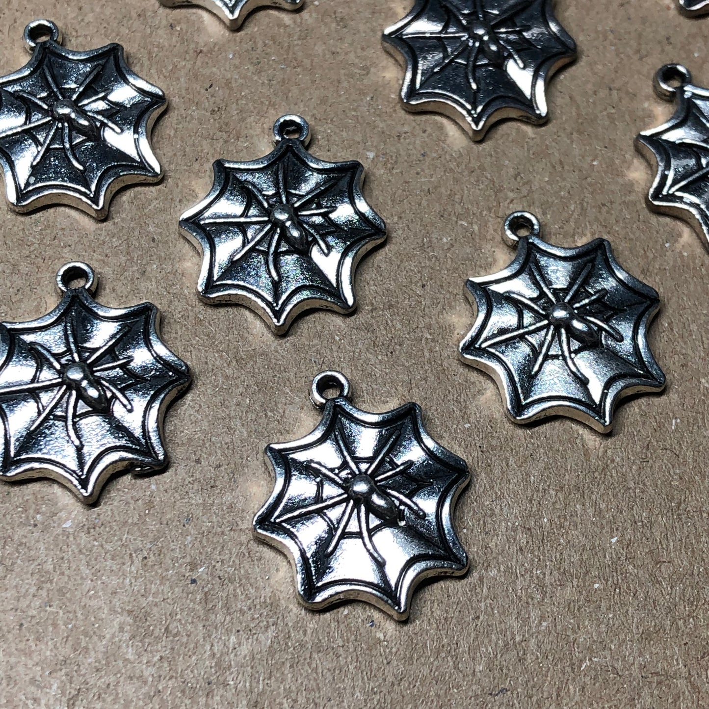 Twelve spiderweb charms