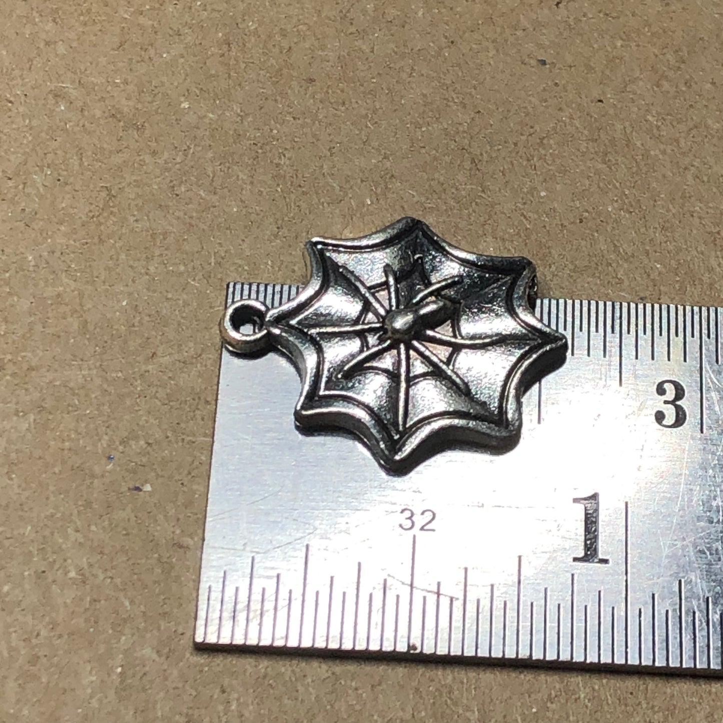 Twelve spiderweb charms