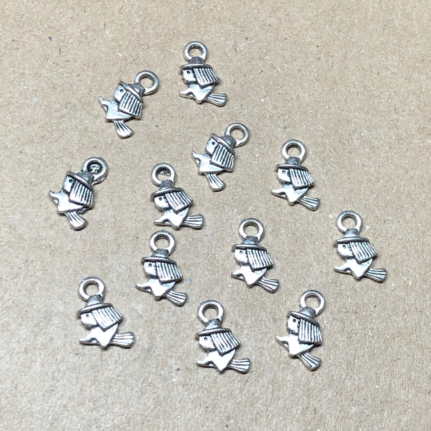 Twelve tiny witch on broomstick charms