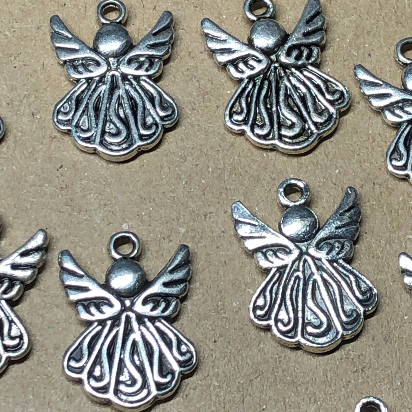 Twelve smooth angel charms