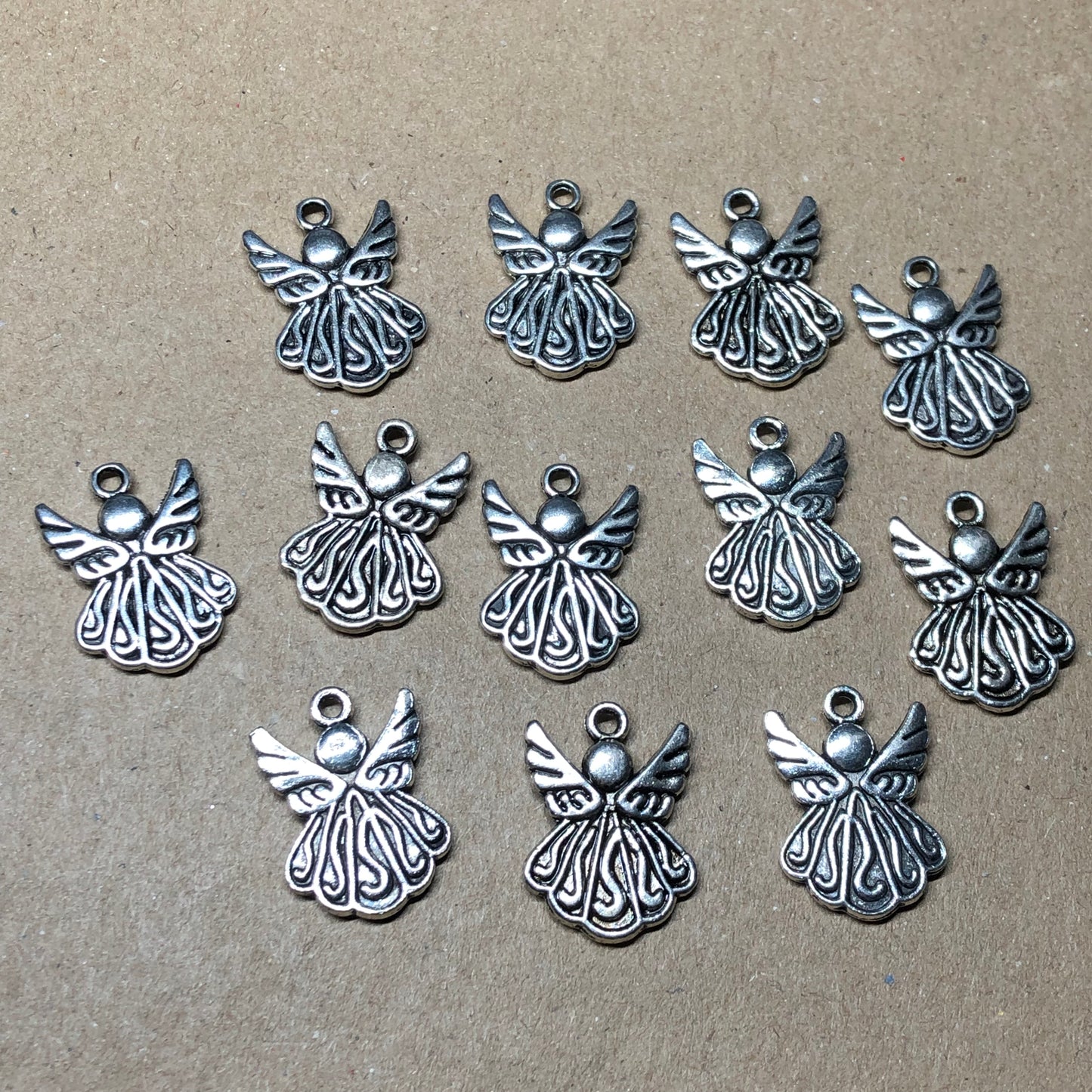 Twelve smooth angel charms