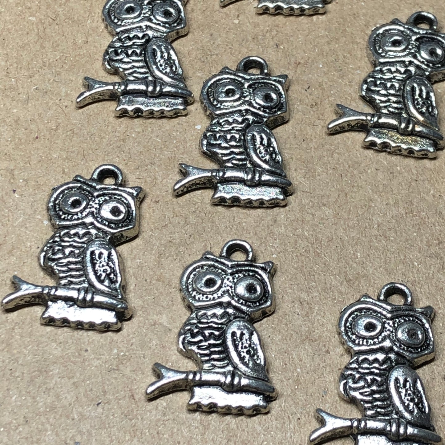 Twelve tall owl charms