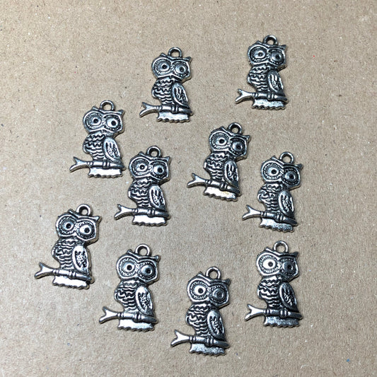 Twelve tall owl charms