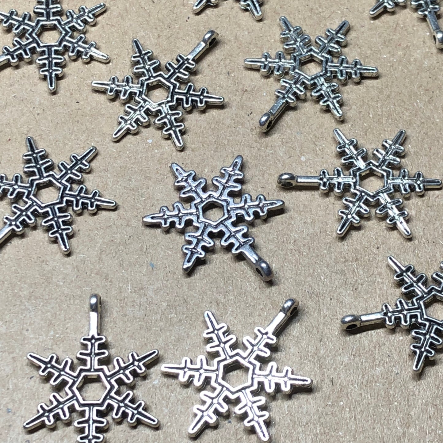 Twelve spikey snowflake charms