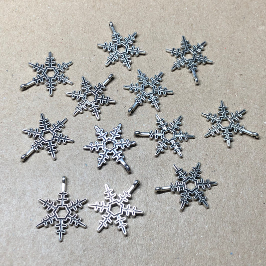 Twelve spikey snowflake charms