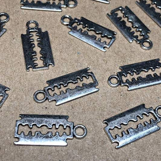 Twelve large razor blade charms