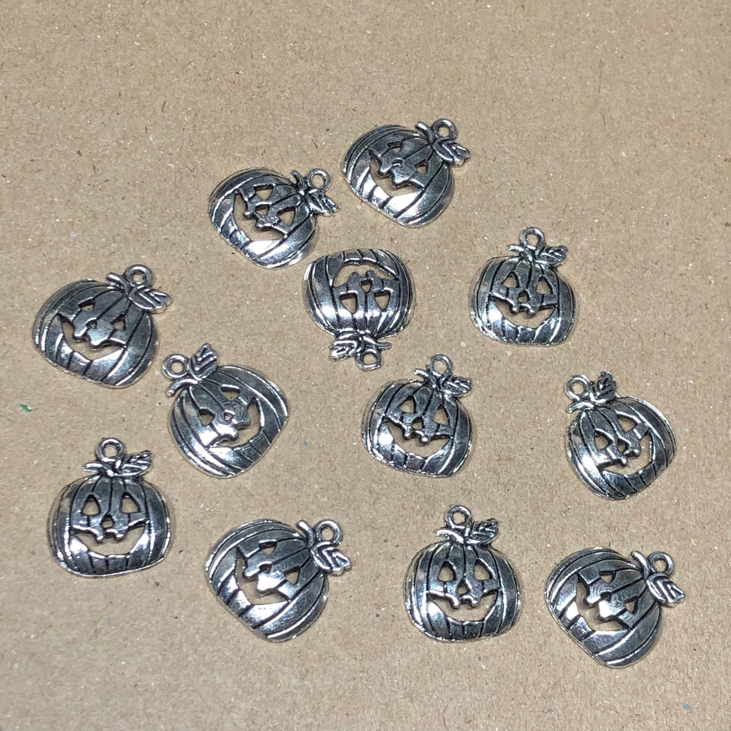 Twelve smiling pumpkin charms