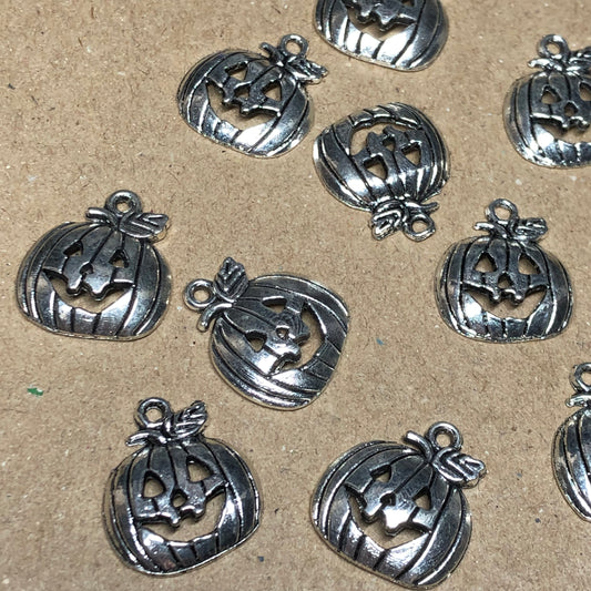 Twelve smiling pumpkin charms