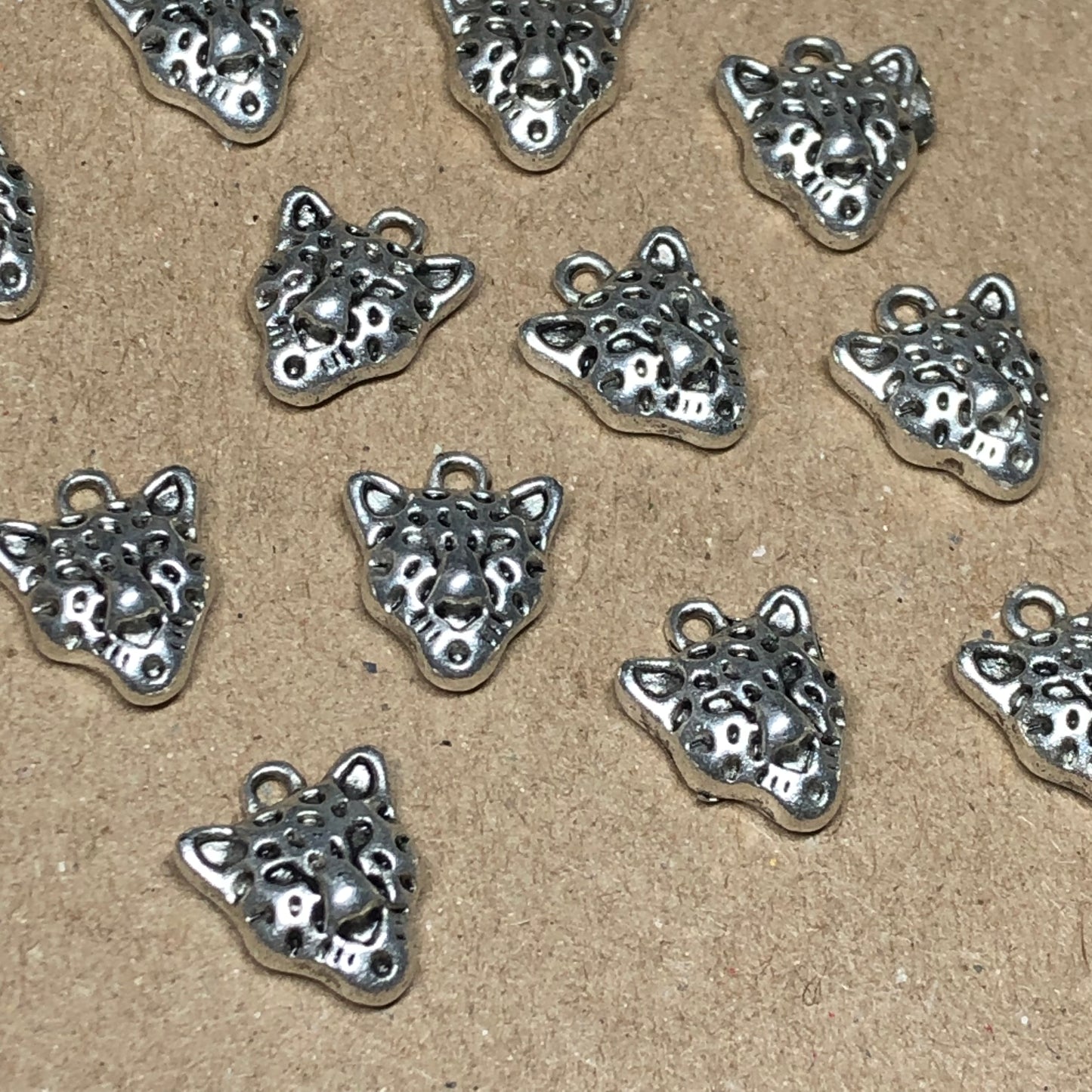 Twelve small cheetah charms