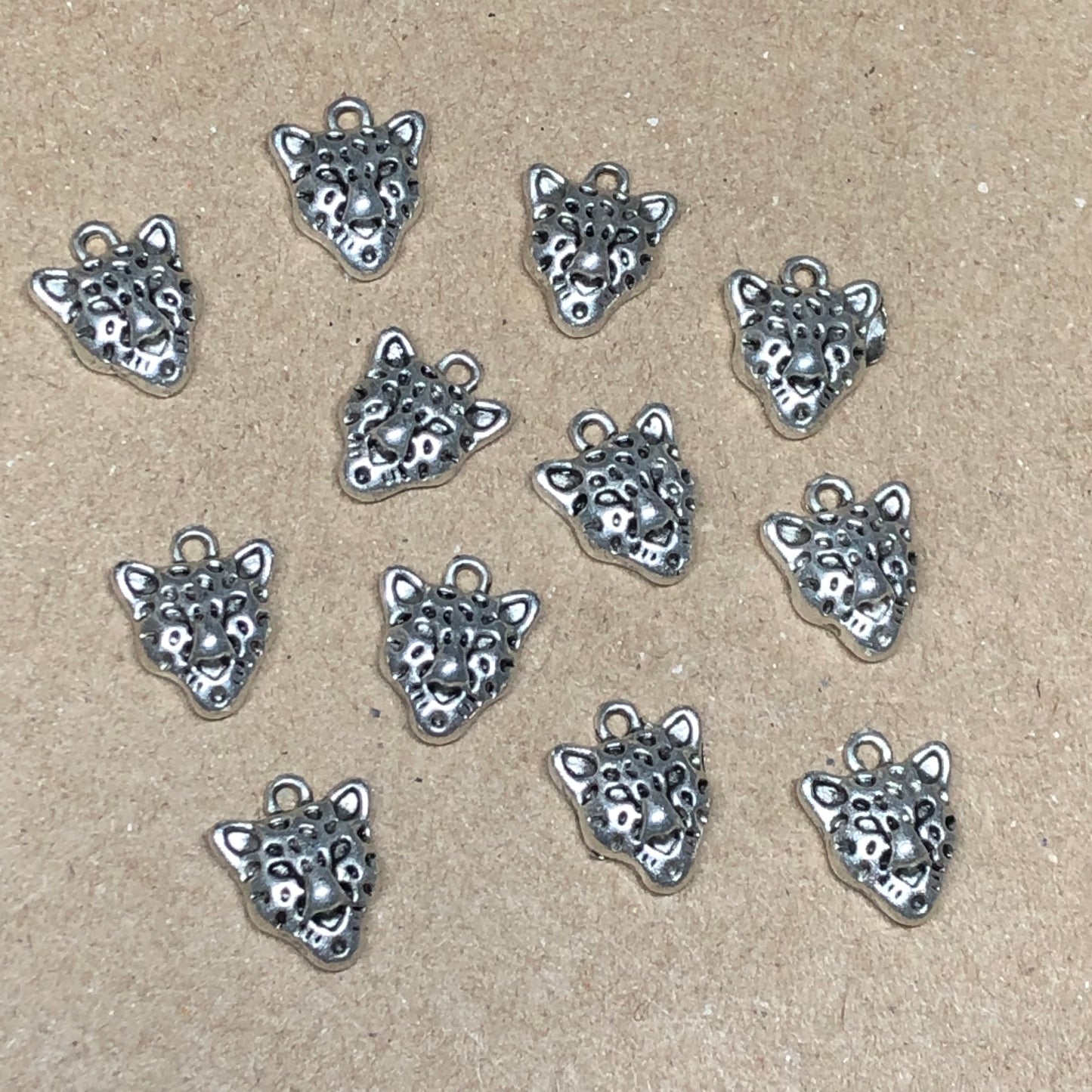 Twelve small cheetah charms