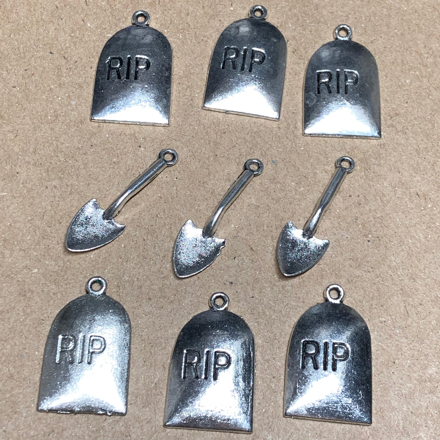 Nine gravestone and spade charms