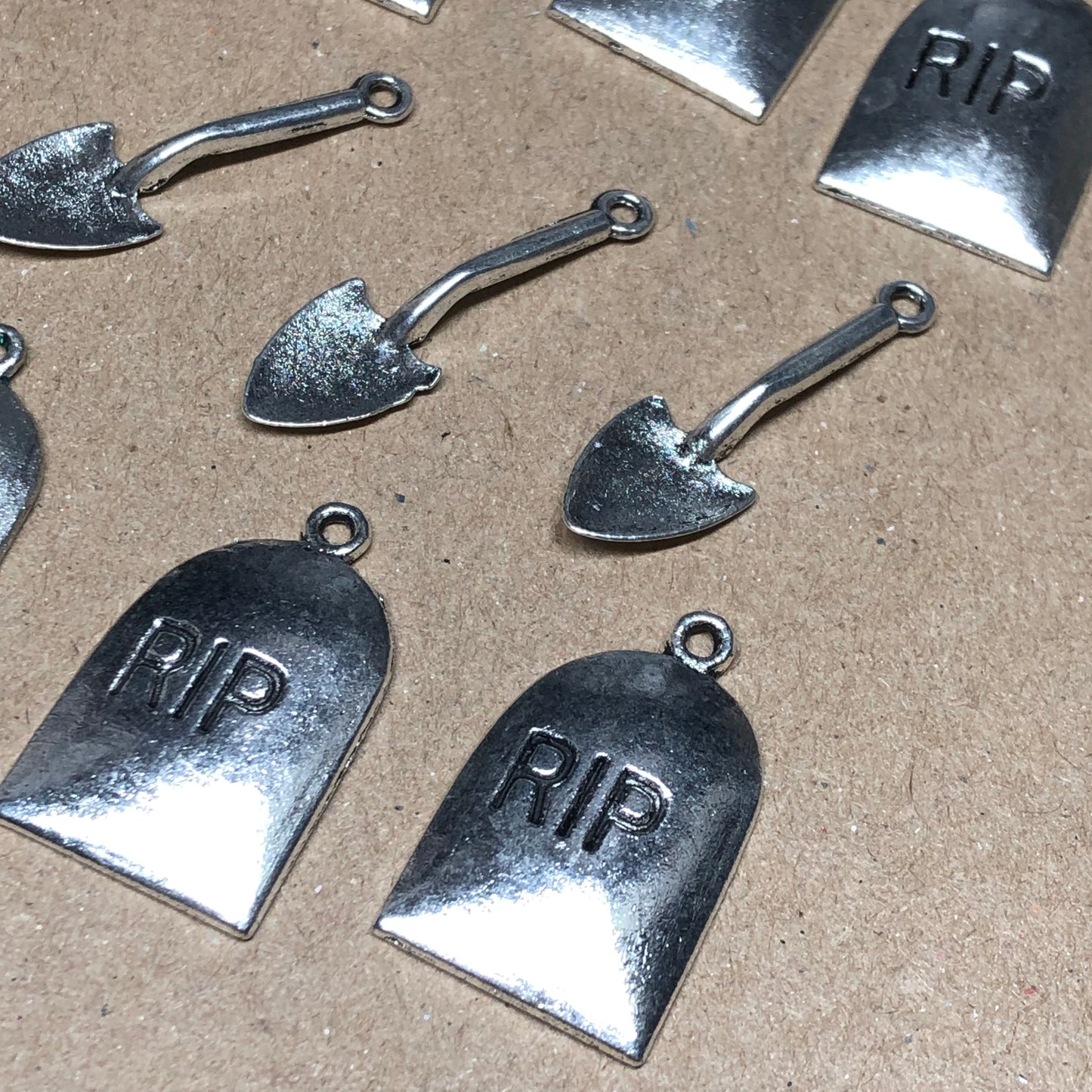 Nine gravestone and spade charms