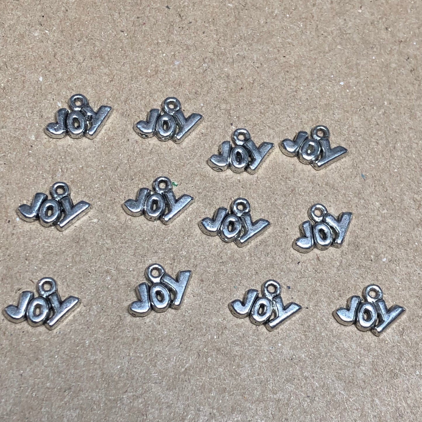 Twelve small Joy charms