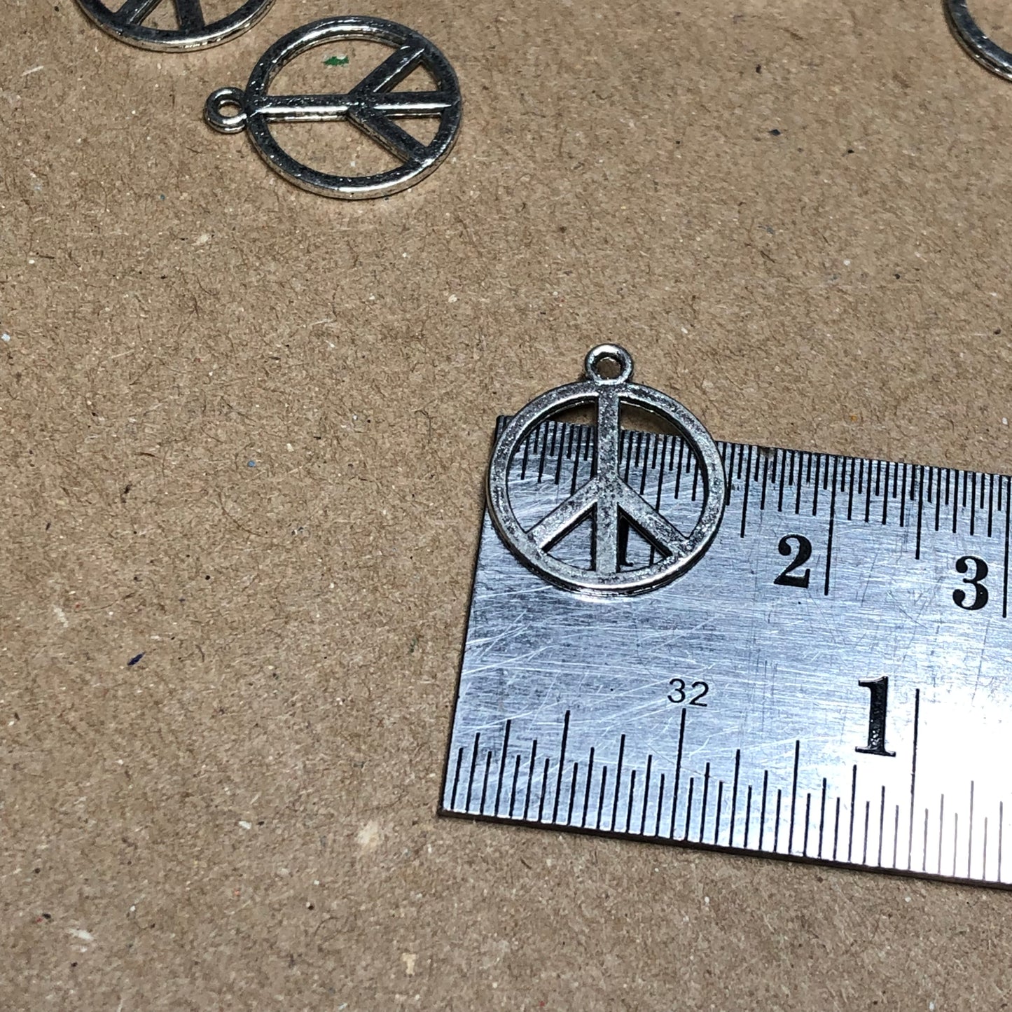 Twelve peace symbol charms