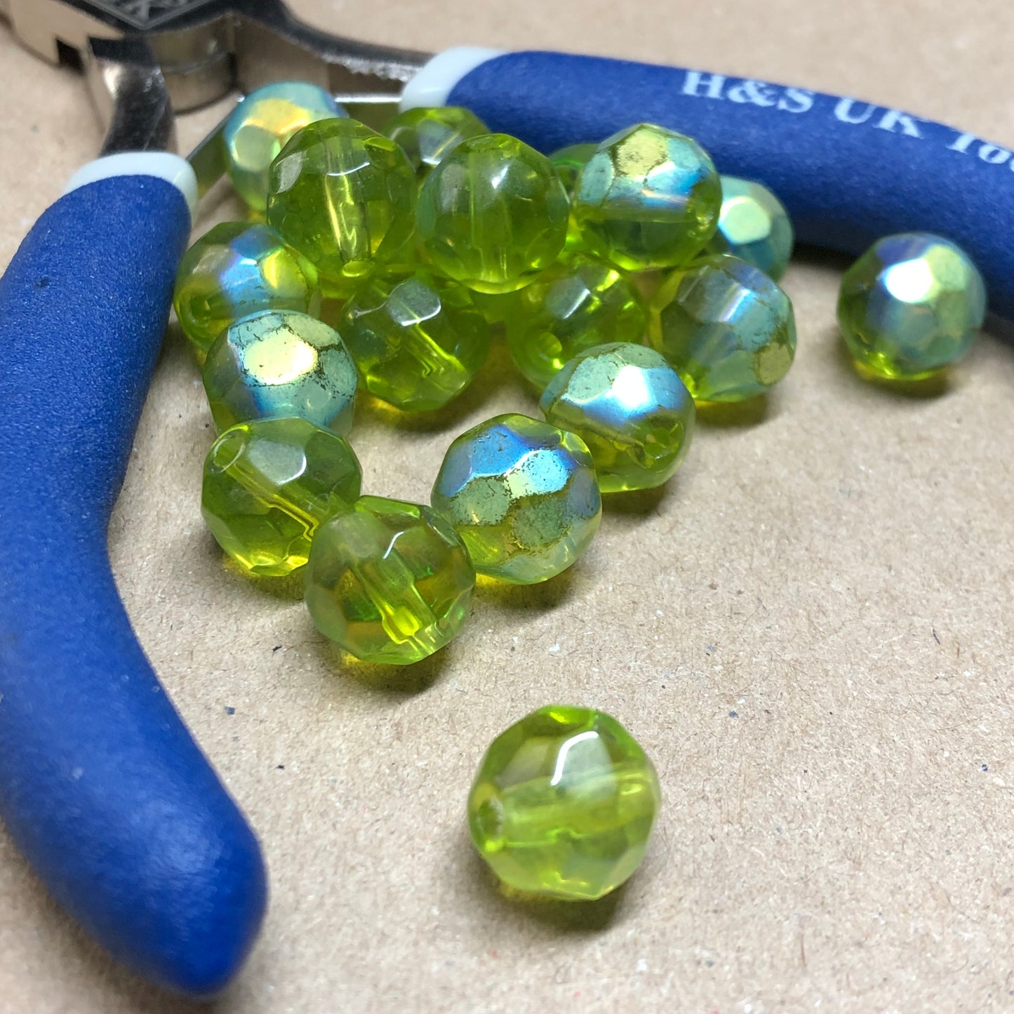 Green iridescent round faceted glass beads