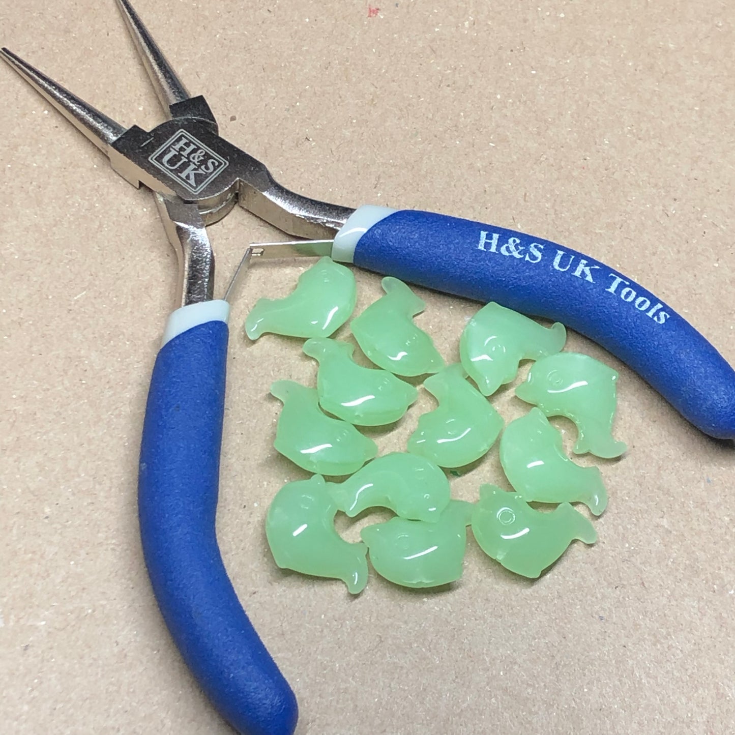 Green opaque dolphin shaped glass beads