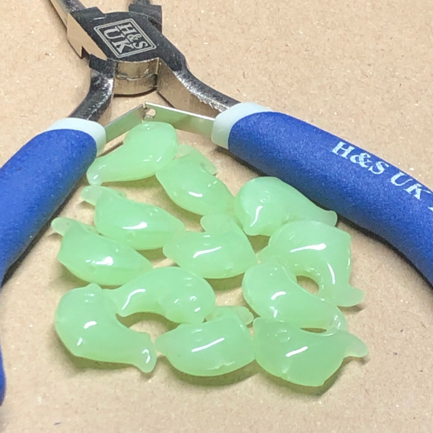 Green opaque dolphin shaped glass beads