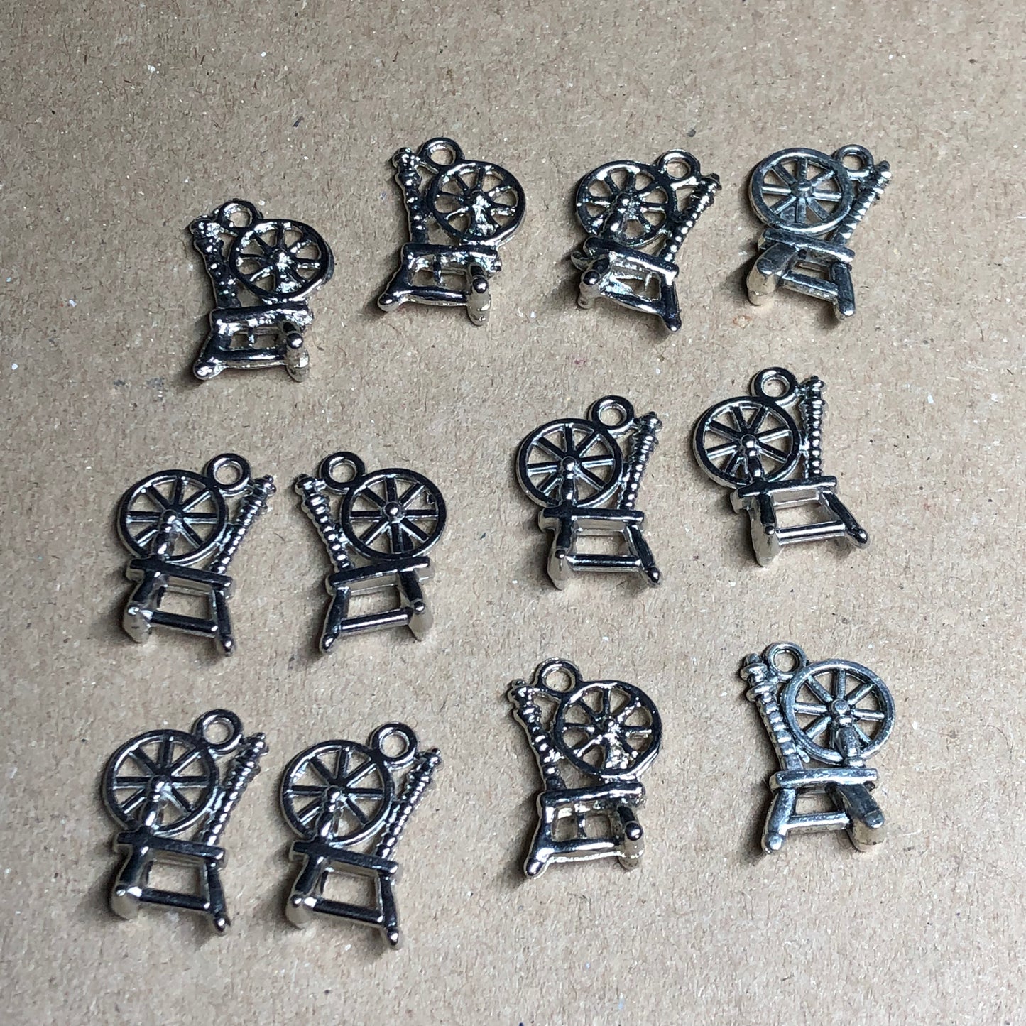 Twelve spinning wheel charms