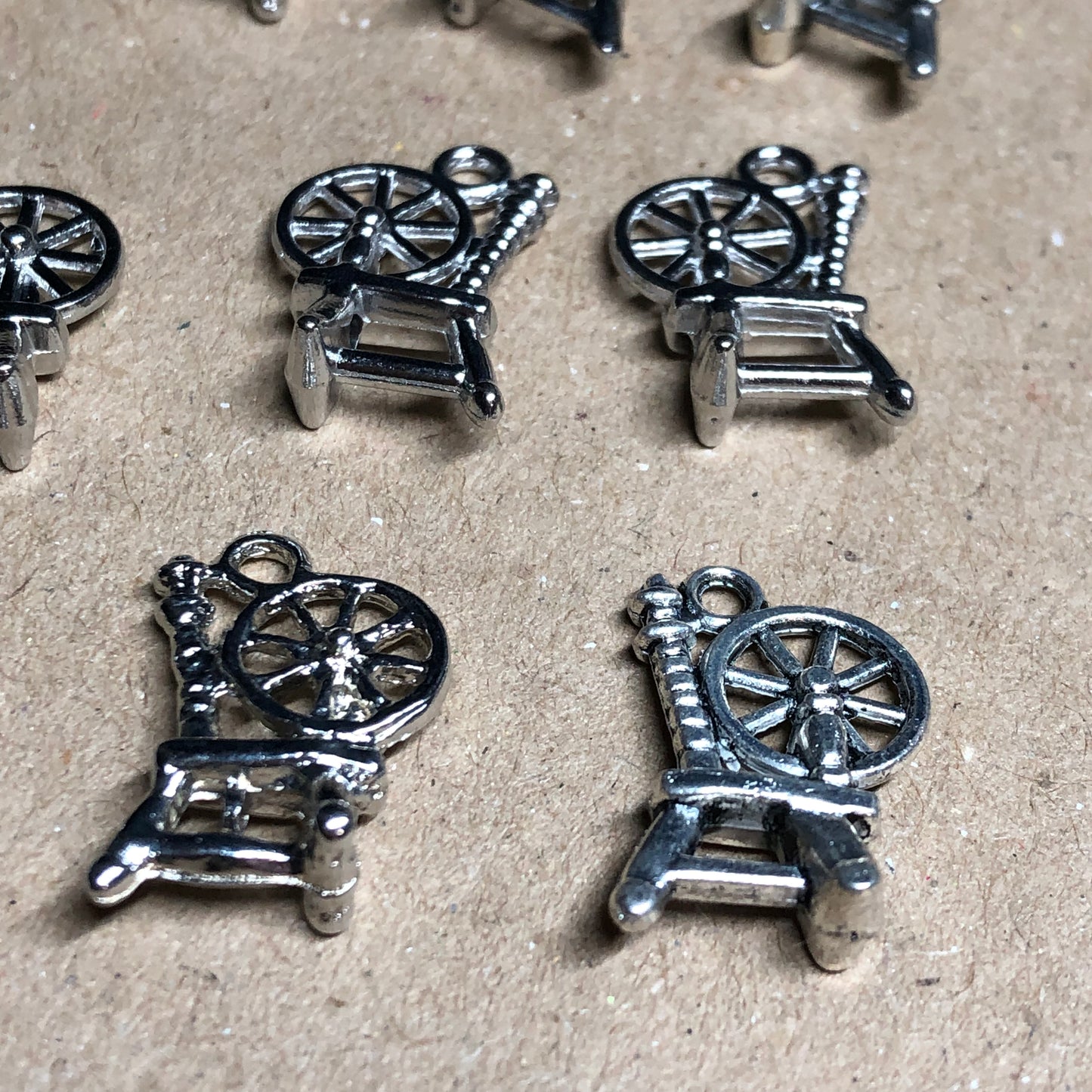 Twelve spinning wheel charms